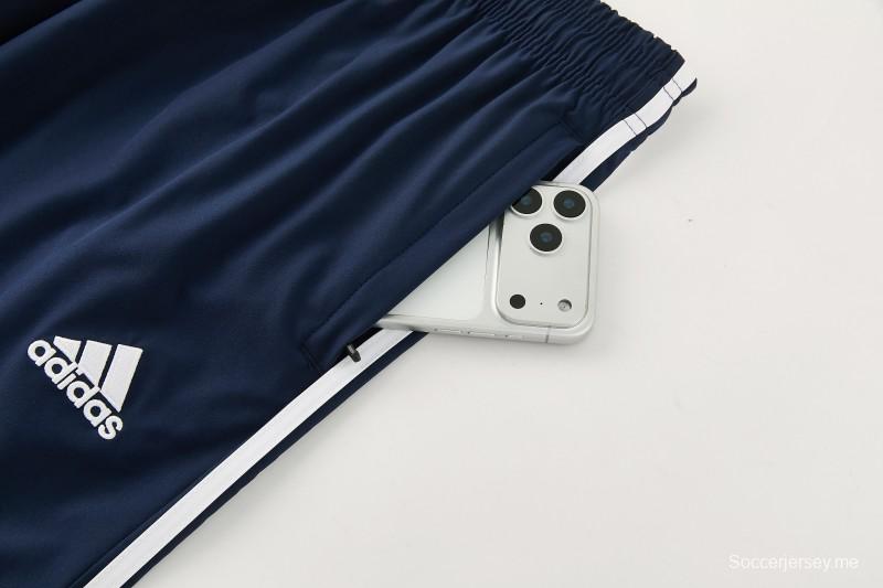 26/27 بدلة رياضية من ريال مدريد باللون الأزرق الداكن مع سترة واقية من الرياح بغطاء للرأس وسحاب كامل + بنطال طويل